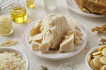 Pieces of shea butter with beeswax, cocoa butter and essential oils - ingredients for natural cosmetics