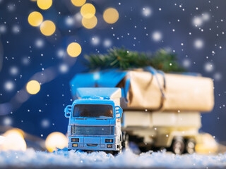 Toy truck carries Christmas gift in snowfall