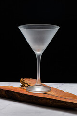 Crystal glass, without drink, on a black background on a marble table