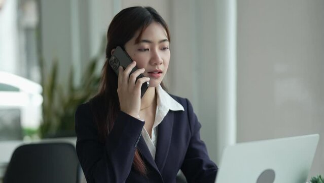 Young female making business call talking on the phone