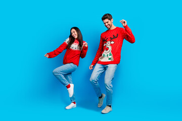 Fototapeta na wymiar Full length photo of lovely young spouses energetic dancing have fun wear x-mas ornament red sweaters isolated on blue color background