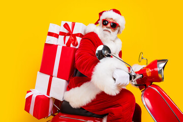 Profile view of cool bearded fat funky santa riding moped carry pile stack gift boxes purchases...