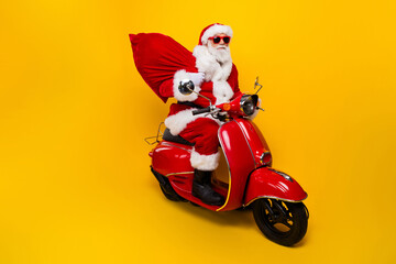 Side photo of grey white hair beard cool santa claus ride drive scooter xmas night deliver present...