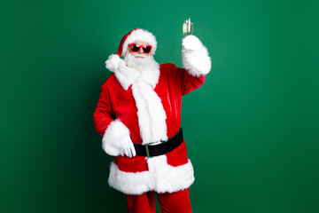 Photo of funky cool claus wear red costume drinking champagne telling christmas wishes isolated green color background