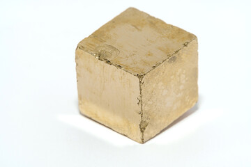 Golden Pyrite Stone in form of cube with white background