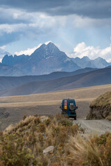  green campervan with a high, snow-capped mountain range