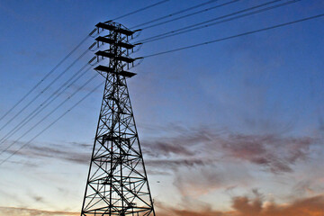 Silhouette of four tier power transmission tower 