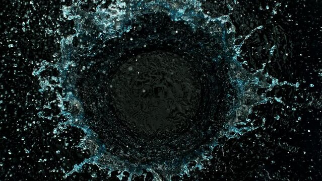 Super Slow Motion Shot of Round Water Splash on Black Background at 1000fps.