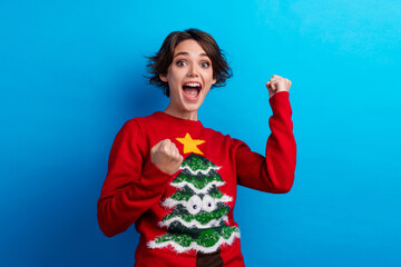 Photo of funky funny woman santa elf wear ornament pullover rising fists celebrating x-mas isolated blue color background