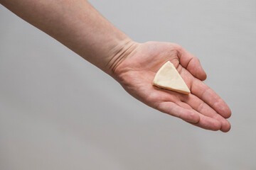 Person Holding a Slice of Cheese in Their Hand