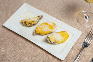 In center of photo are oysters served with aged Cava wine. Oysters on curly halves of shells....