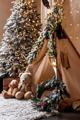 Children's room decorated in Christmas style. Wooden sleigh, gifts and hut for children to play. © sergiophoto