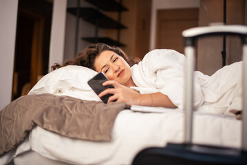Beautiful female traveler in the hotel room