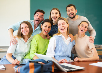 Group portrait of cheerful group of university students in classroom