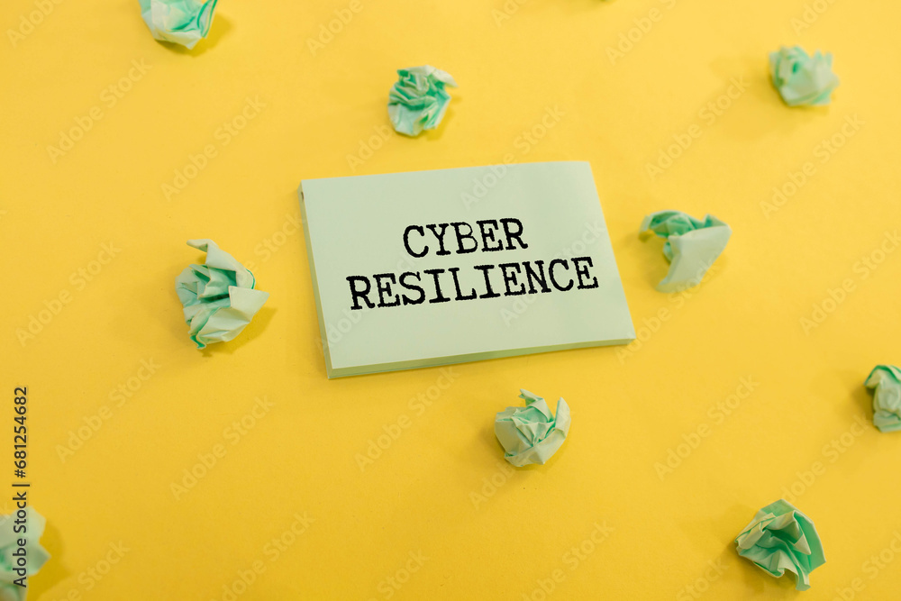 Poster cyber resilience, text on white notepad paper on gray background. notepad on white keyboard.