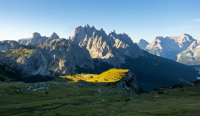 Amazing views of the picturesque high Dolomites mountains, lawns and summer forest