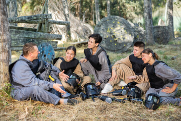 Team of paintball players discussing the past game