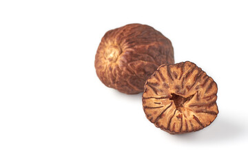 Two dried nutmegs isolated on white background