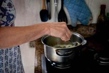 Meat and onions being fried in the pan.