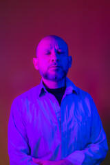 Bald, bearded man wearing business clothes