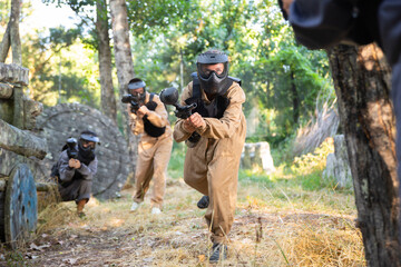 Fototapeta premium Attack of the paintball team on the enemy at the army training ground