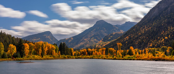 Fast Moving Clouds Over Marble Lake Colorado Autumn Landscape Scene. Bright Blue Sunny Sky with Clouds Over Yellow Aspen Trees.