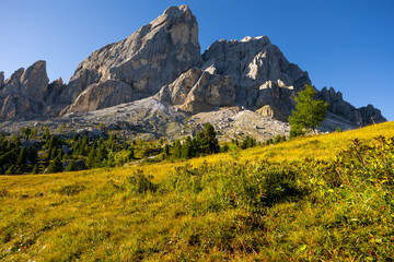 Picturesque mountain landscape overlooking rocky pinnacles of Munt de Fornella framed by greenery...