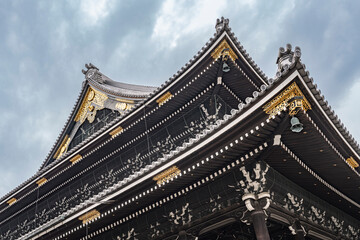 Curved rooftops in the Higashi Honganji temple in Kyoto, Japan (Translated text in tiles...
