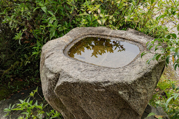 Water ladle and basin for cleansing at shrine in Kyoto, Japan.
Stone basin or bird bath in zen...