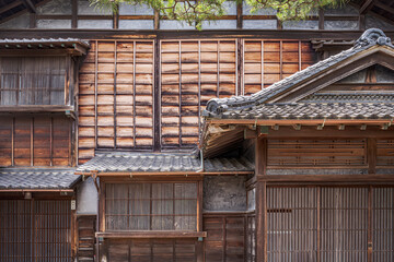 Wooden walls and screens for privacy in Japanese houses.
Weathered wood panels used in historic houses in Japan.
