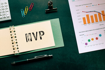 There is notebook with the word MVP. It is an abbreviation for Minimum Viable Product as...