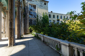 abandoned building with a colonnade, former sanatorium - obrazy, fototapety, plakaty