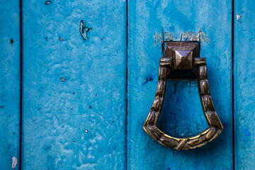 Old wooden doors with an old metal door handle knocker in Brazil