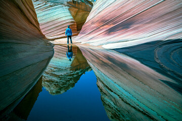 A man standing in the Wave. The Wave is an amazing natural feature found in the northern section of Coyote Buttes about mid-way between Page, Arizona and Kanab, Utah. 