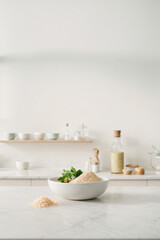 Fototapeta na wymiar Island kitchen with minimalist elements in Scandinavian style on a bright day