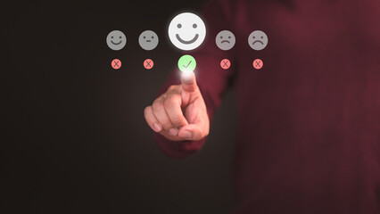 Male hand touching the virtual screen on happy smile face icon to give satisfaction in service. Online review concept of assessment testimonial customer service and feedback, Opinion rating very good.