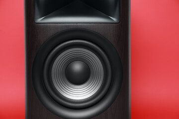 One wooden sound speaker on red background, closeup