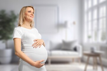 Happy young pregnant woman at home