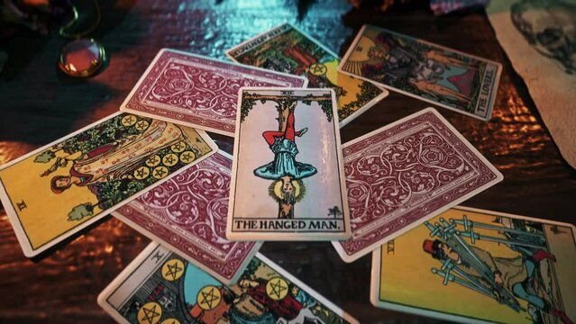 Copenhagen, Denmark - October 4, 2021. Mystic future divination tradition of Tarot Card interpretation. Mystic future divination of The Hanged Man Card. Mystic divination of future personal sacrifices