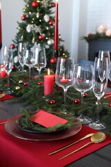 Elegant Christmas table setting with blank place card and festive decor