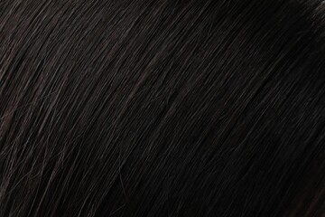 Closeup view of healthy dark woman`s hair