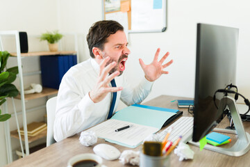 Stressed boss screaming having work problems at the office