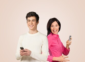 Happy young couple or friends use mobile phone