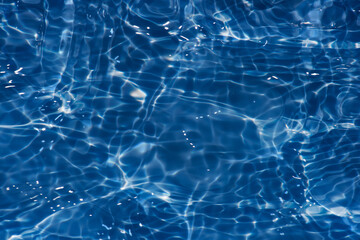  Blue water with ripples on the surface. Defocus blurred transparent white-black colored clear calm...