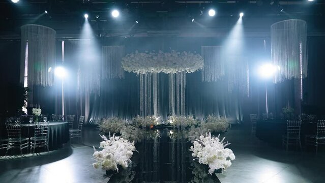 Wedding arch in the festive banquet hall. The camera shoots smoothly approaching