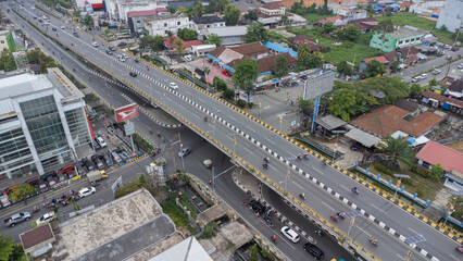 Fototapeta na wymiar The long flyover in Banjarmasin is passed by many cars and motorbikes