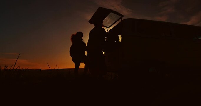 Road trip, sunset and silhouette of people in car for adventure, journey and freedom outdoors. Travel, transport and friends with bag in motor vehicle for holiday, vacation and weekend in nature