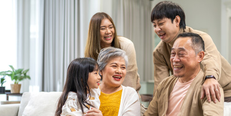 Fototapeta na wymiar Portrait of happy love family asian father and mother playing with adorable asian kid girl.daughter, care, insurance.Happy family moments good time love with grandparents.Love of big family