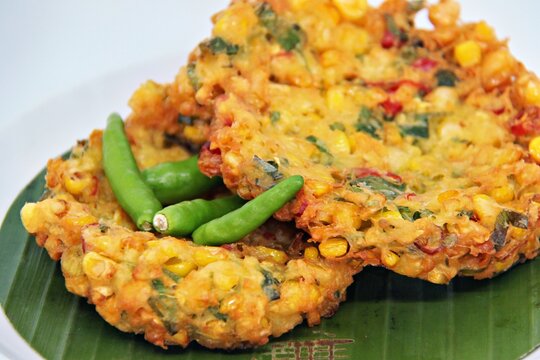 Jakarta, Indonesia - August 29, 2023: Perkedel Jagung or Bakwan Jagung, corn fritters is Indonesian traditional food. Savoury snack made of corn, egg, flour, spring onion, pepper and salt.