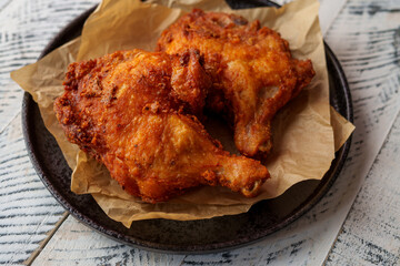 Crispy chicken thighs fried on a wooden table
